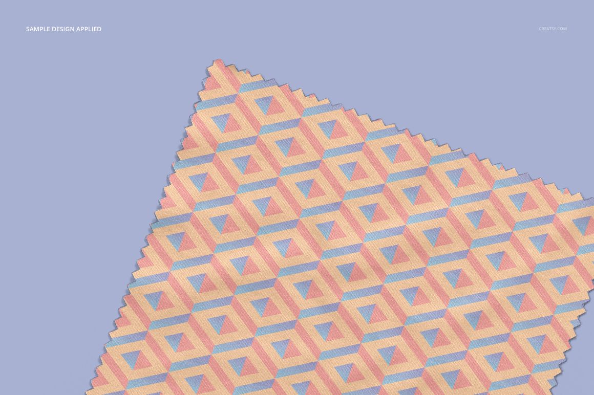 Mockup of a microfiber cleaning cloth for glasses featuring a cube-like geometric design in soft pink and blue tones.