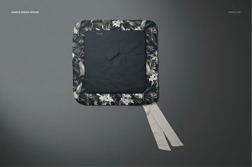 Flat-lay view of a muslin baby wrap mockup featuring a dark floral pattern border and plain central panel.