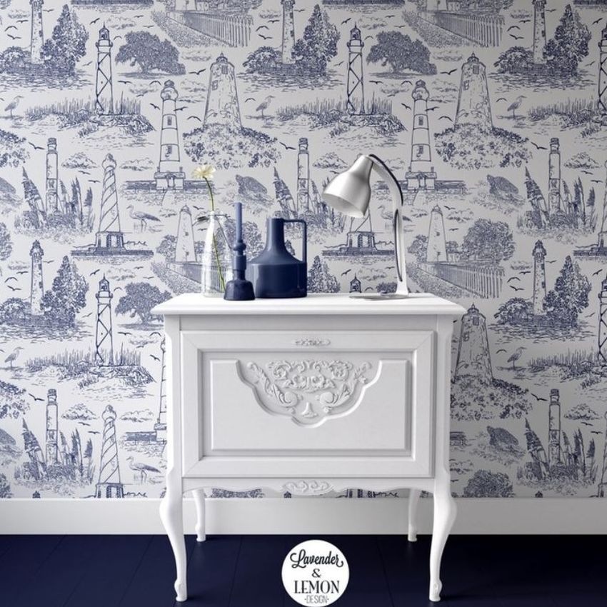 Interior scene mockup showing a white vintage nightstand with a lamp, vases, and a single flower, set against blue and white lighthouse patterned wallpaper.