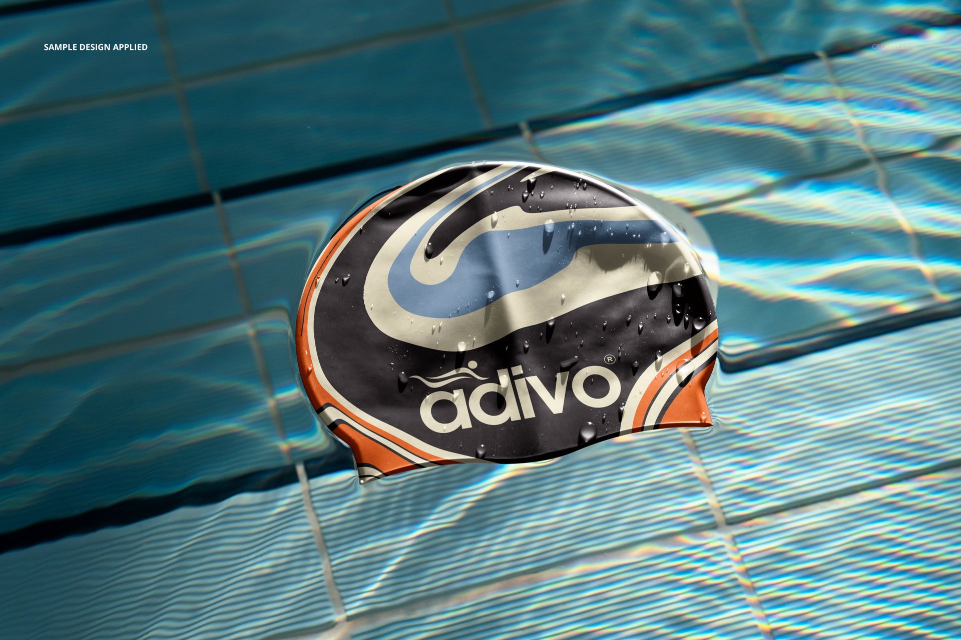Swimming cap mockup featuring a dynamic pattern and water droplets, positioned on blue pool tiles, top view.