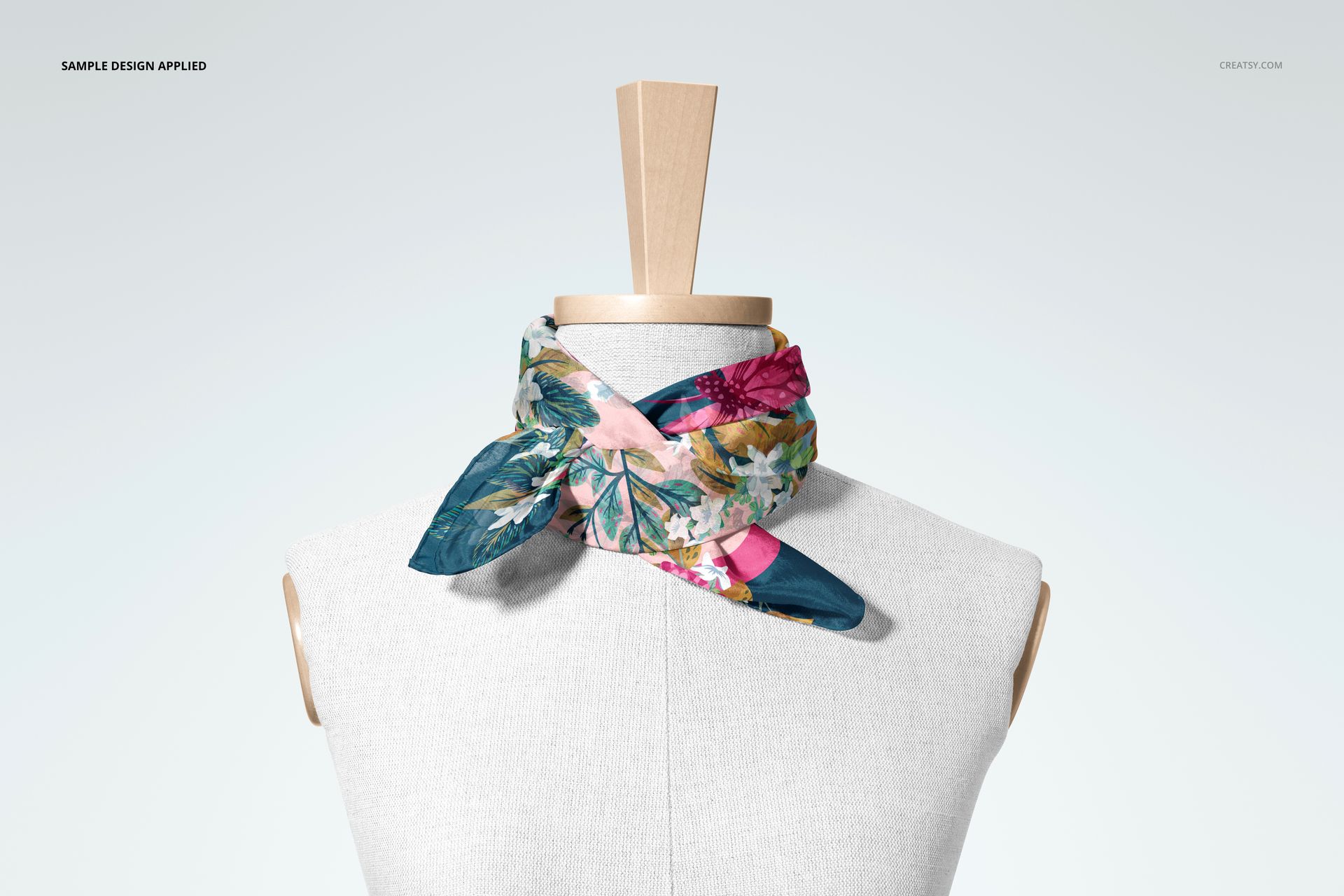 Front view of a mannequin with a habotai silk scarf mockup, featuring a colorful floral pattern and hand-rolled edges.