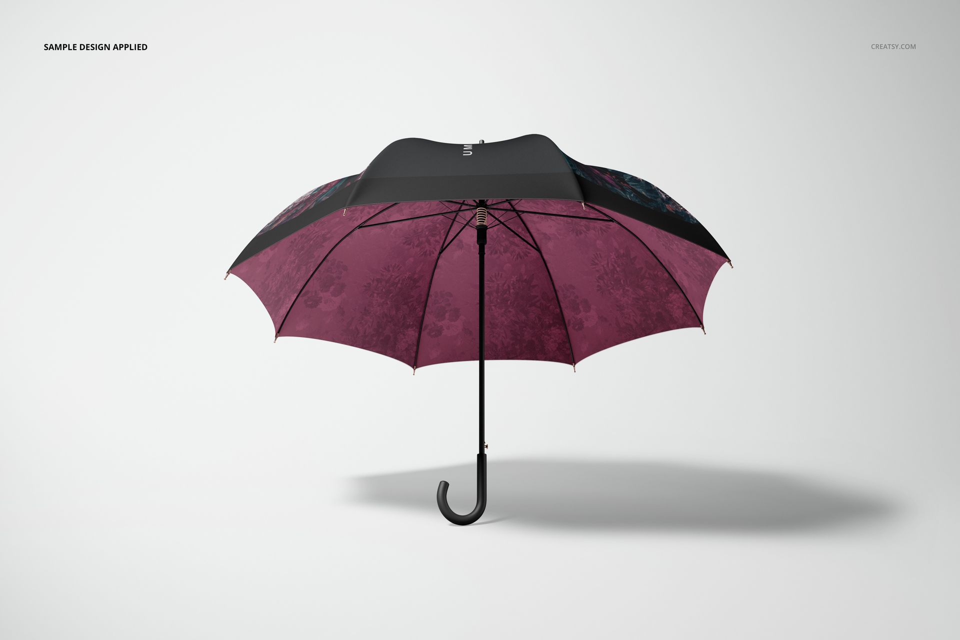 Fashion accessory umbrella mockup showing a black and maroon canopy with faint floral details, displayed on white background.
