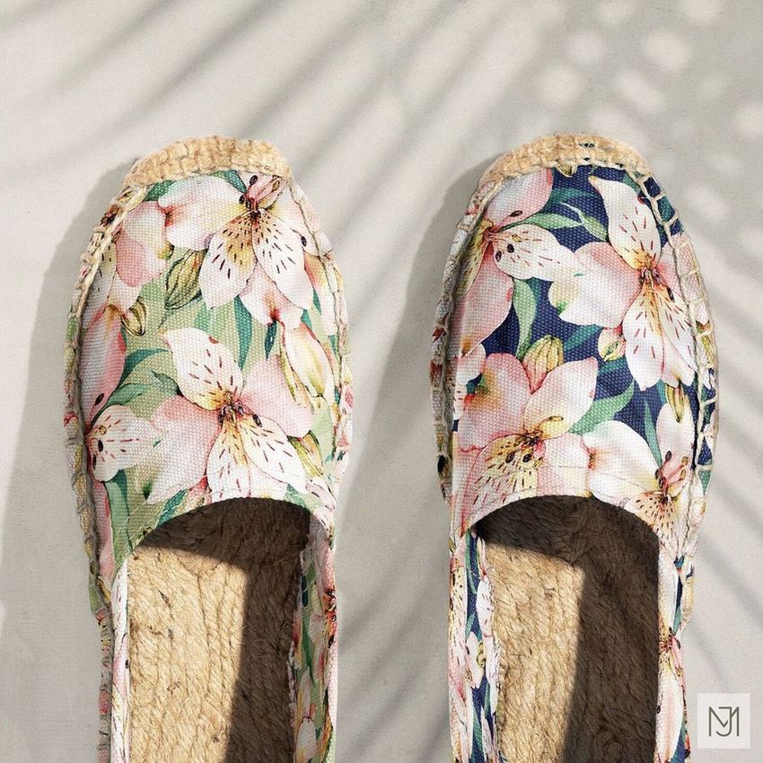 Canvas espadrilles mockup featuring a pair of shoes with tropical floral patterns, photographed from above on a light surface.