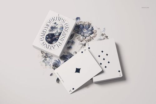 Playing cards mockup featuring a deck and two cards on a white surface with blue floral illustrations underneath.