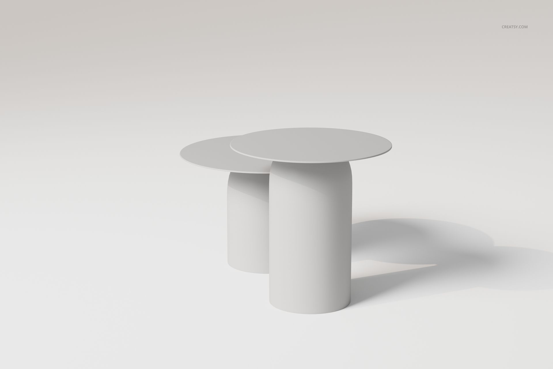Two round Nordic style disc coffee tables with cylindrical bases in a minimalist light setting, front angle view.