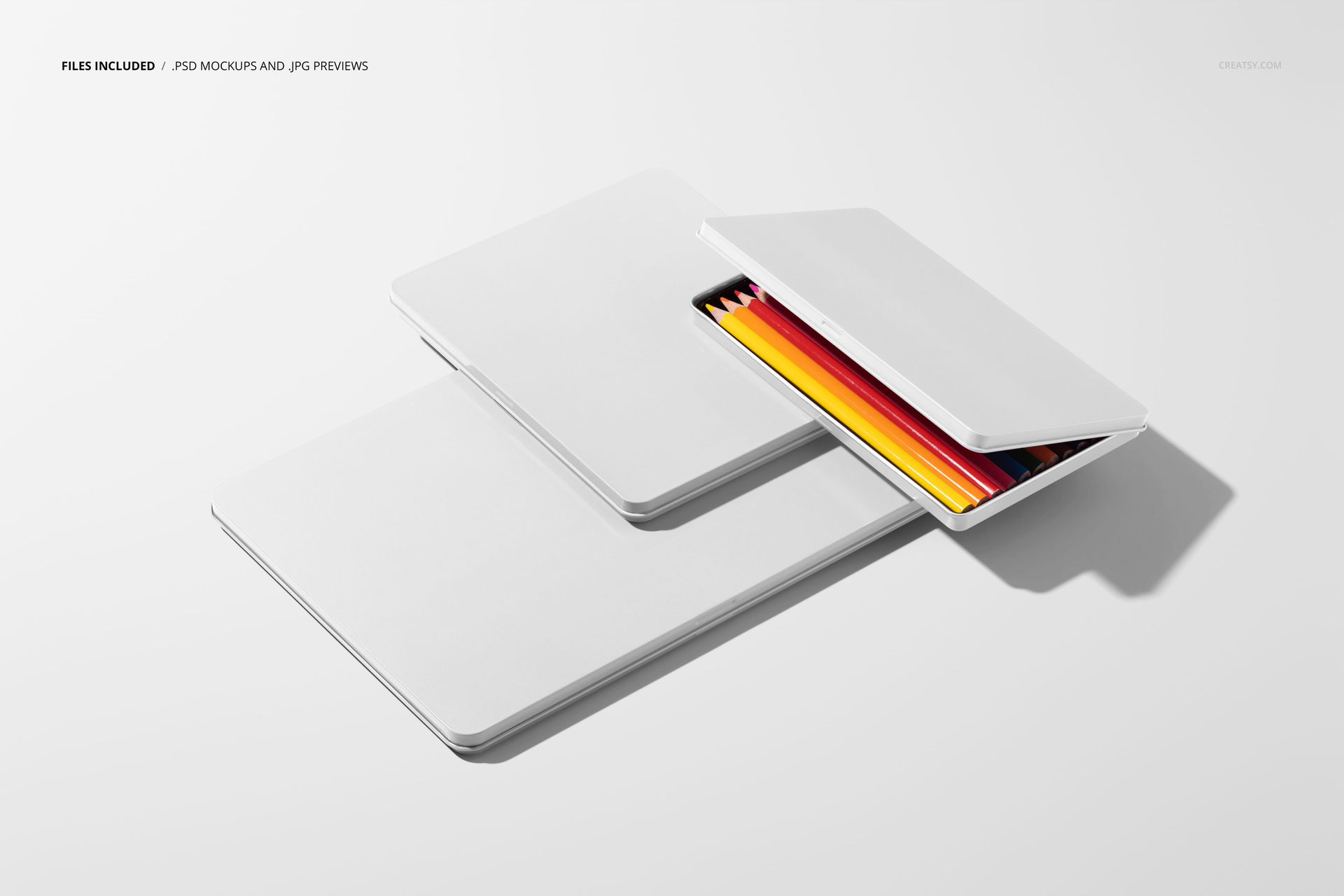 Top perspective of blank crayon boxes mockup, with one box open revealing neatly arranged colored crayons inside.
