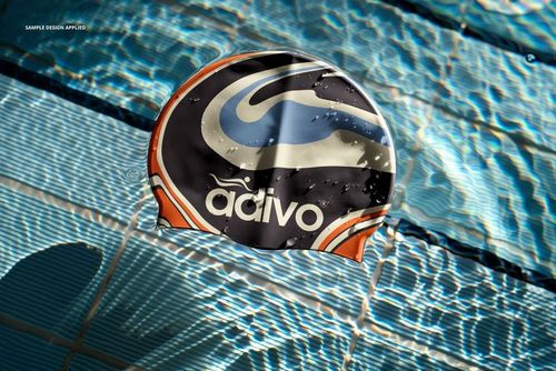 Top view of a swim cap mockup featuring a colorful pattern, placed in clear blue pool water with light reflections.