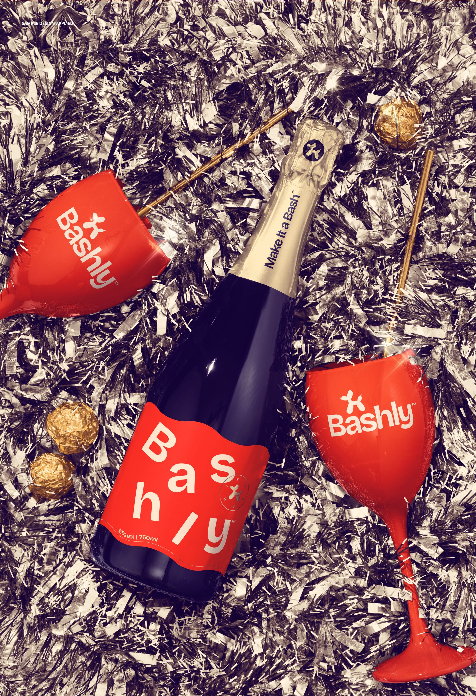 PSD mockup showing a champagne bottle and red glasses surrounded by metallic silver tinsel decorations.