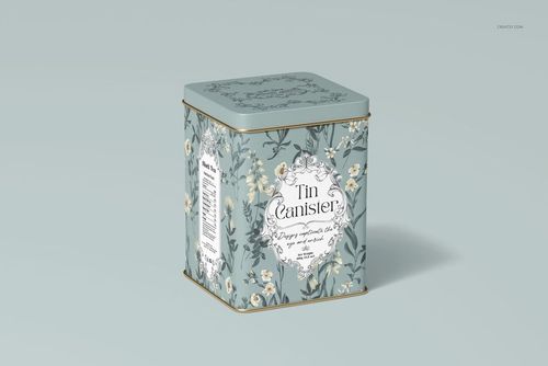 Floral patterned tin canister mockup in blue and cream colors, displayed at a three-quarter angle on a pale surface.