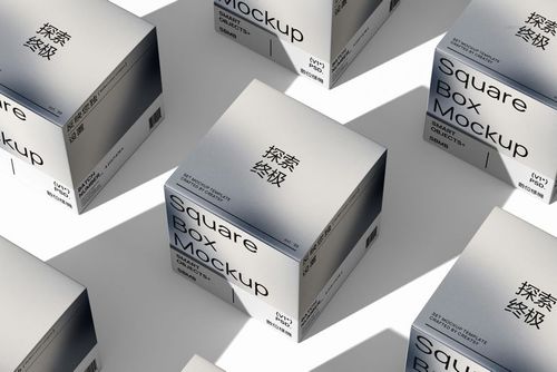 PSD mockup of square boxes with simple black lettering on white surfaces, shown from an overhead diagonal viewpoint.