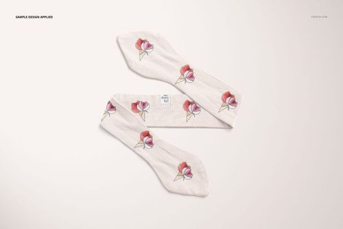 Top view of a swaddle set mockup featuring two white swaddle blankets with a floral ice cream cone pattern on a light background.