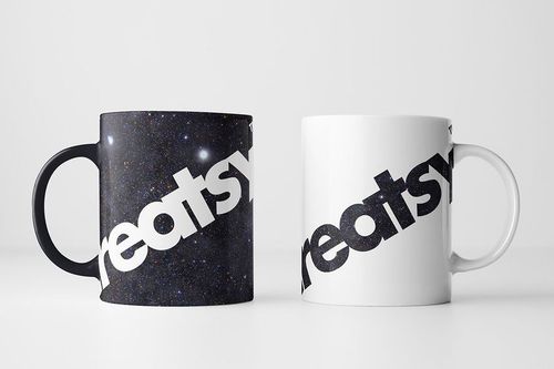 PSD mockup showing a pair of mugs, one with a cosmic pattern and one minimalist white, both with prominent diagonal text.