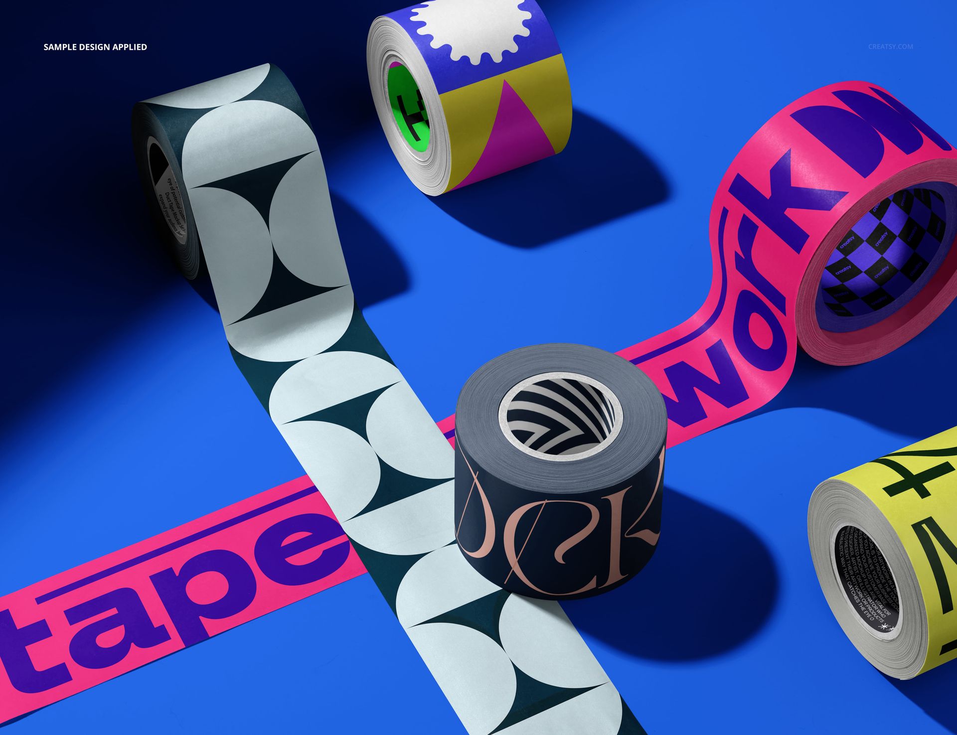 Assorted packaging tapes featuring abstract patterns and vibrant colors arranged on a blue background, PSD mockup style.