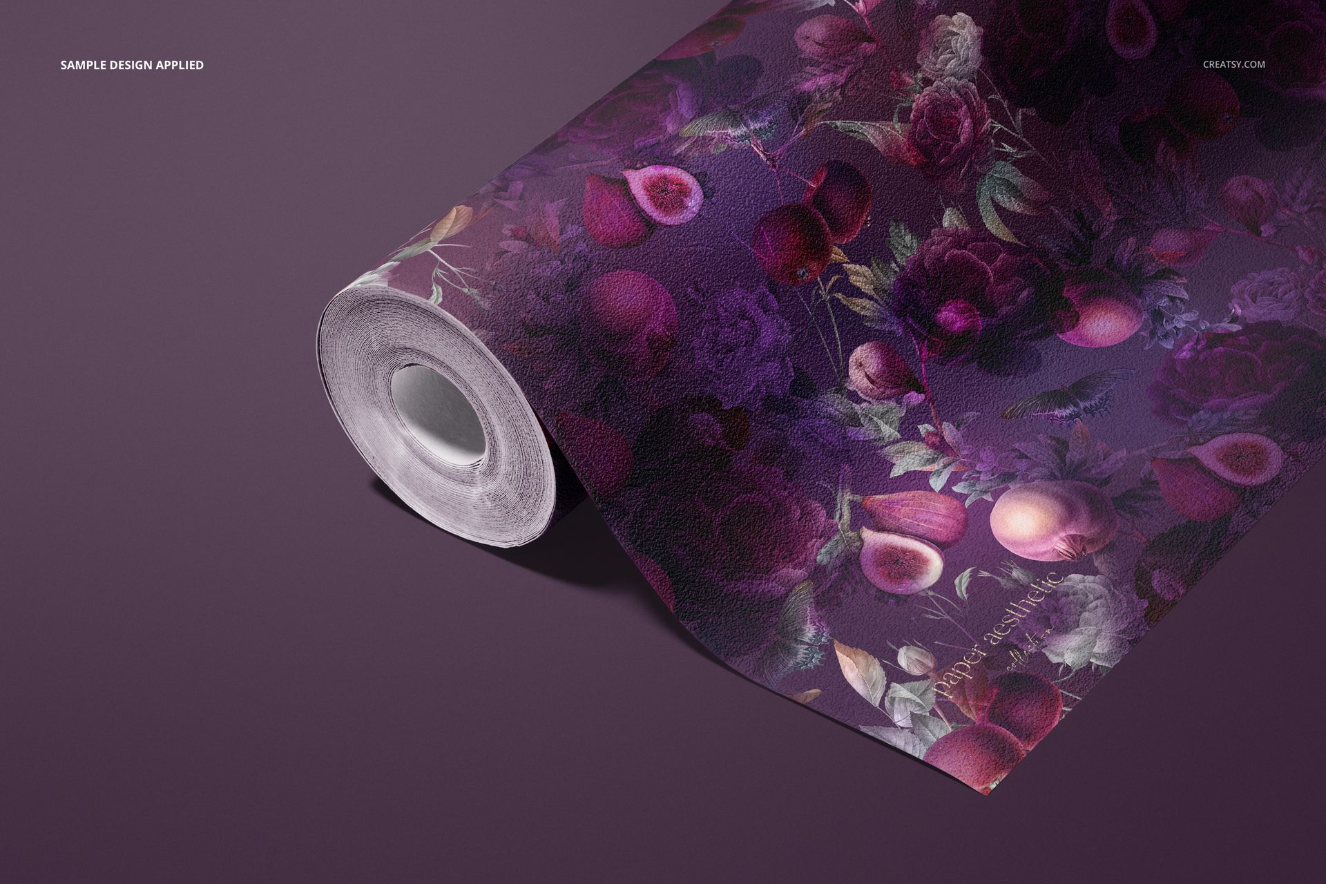 Non-woven vinyl wallpaper mockup roll with vivid purple and pink floral design, displayed on a solid surface.