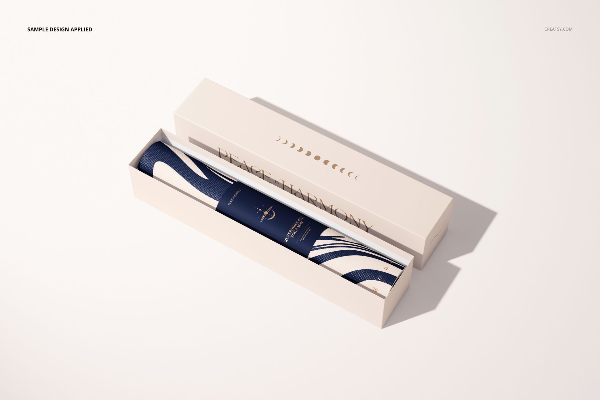 Yoga mat mockup featuring a rolled mat with wavy blue and white design inside an open cream-colored box, seen from above.