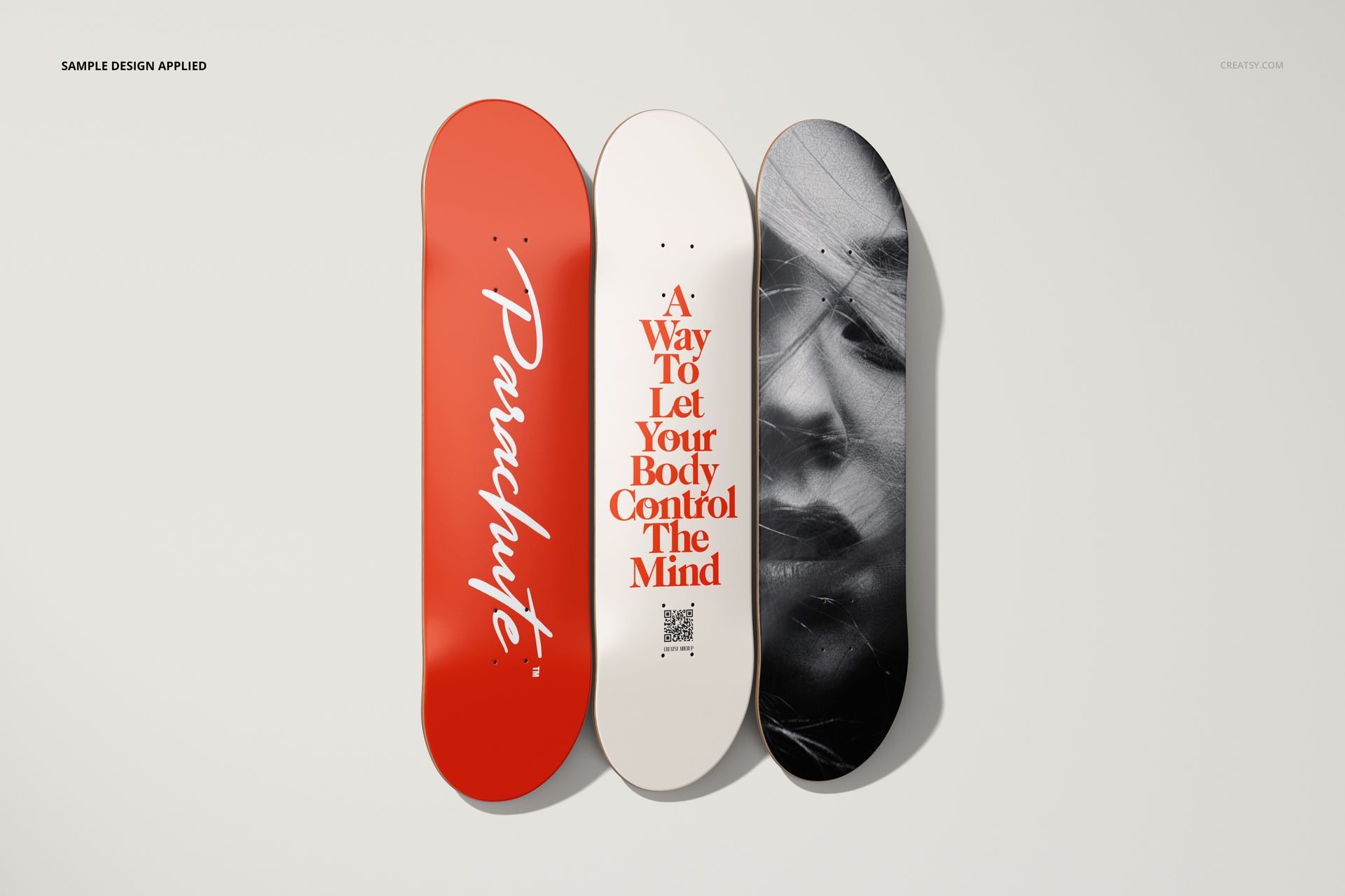 PSD mockup showing three skateboard decks upright on a plain background, highlighting varied artwork styles.
