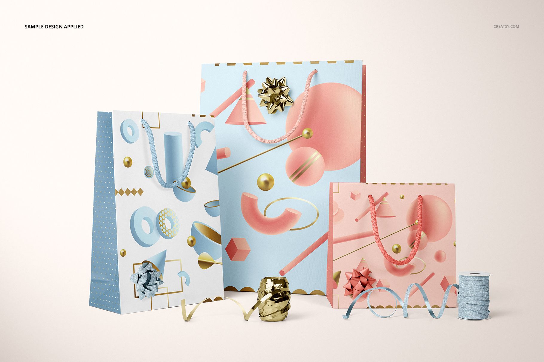 PSD mockup of gifting paper bags featuring blue and pink designs, gold accents, and assorted ribbon props.