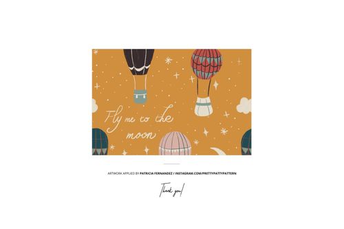 Front view of a baby snowsuit mockup with hot air balloon and star pattern on an orange background.