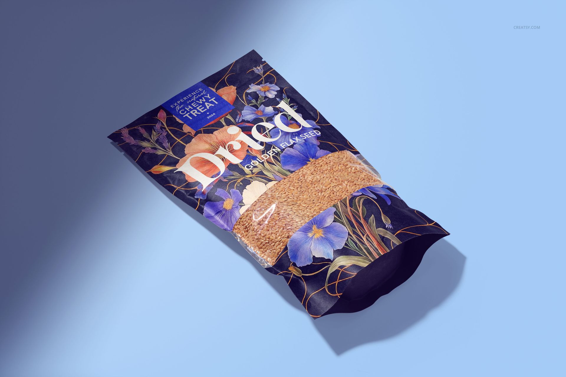 Front view of a paper pouch mockup containing golden flax seeds, featuring a floral design and blue background.