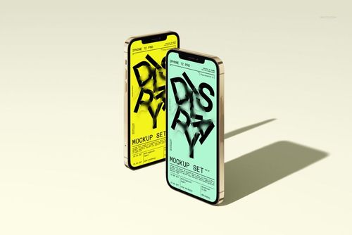 Two iPhone 12 Pro devices standing upright on a light surface, displaying colorful mockup screens in yellow and green.