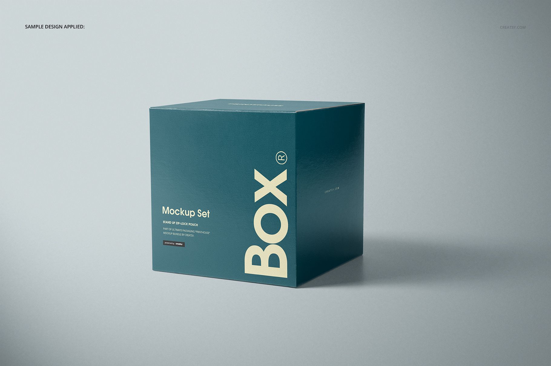 Teal glossy square box mockup with large white lettering, displayed in a studio setting with soft shadows.