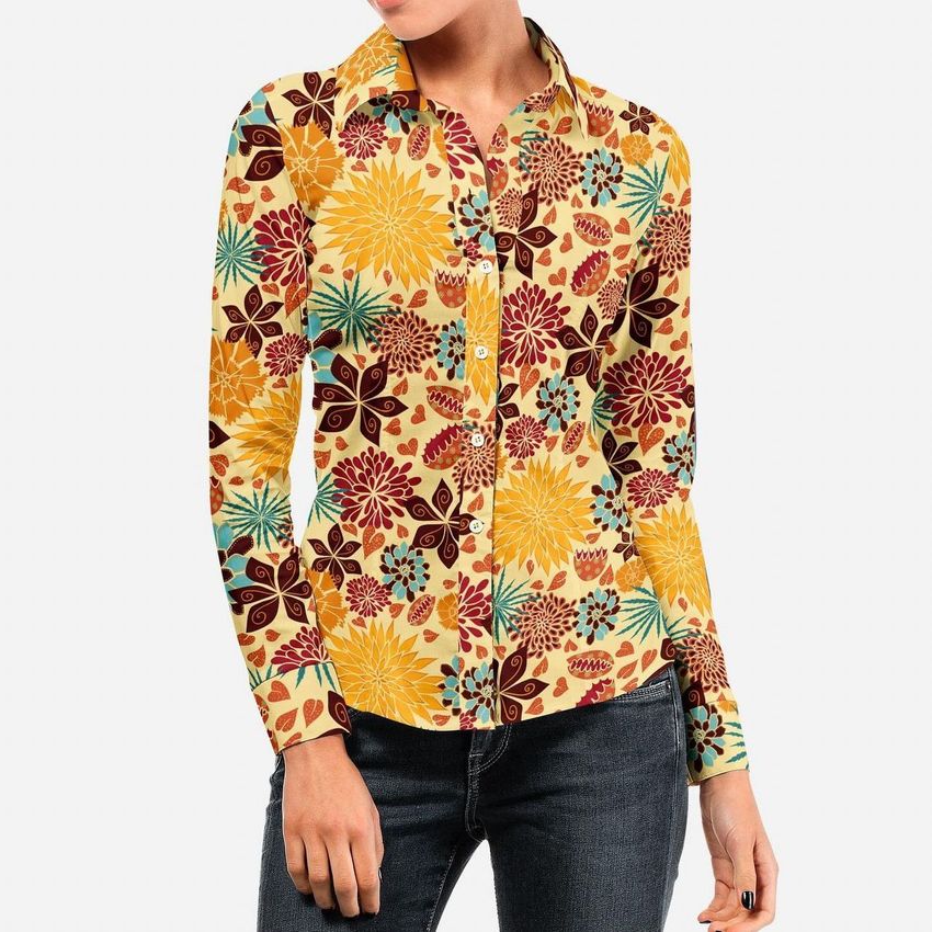 Woman wearing a dress shirt mockup with a colorful floral pattern in yellow, red, and teal, paired with dark jeans.