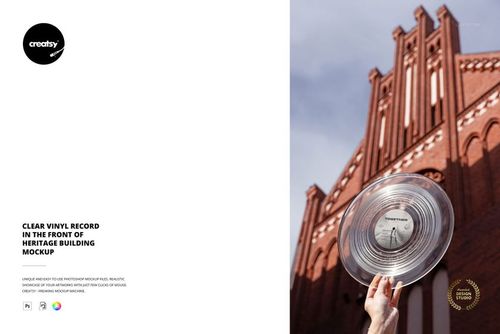 PSD mockup featuring a clear vinyl record raised against the facade of a tall, ornate red brick heritage structure.