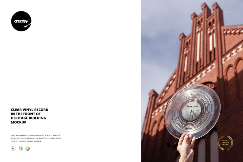 PSD mockup featuring a clear vinyl record raised against the facade of a tall, ornate red brick heritage structure.