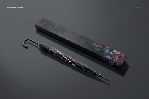 Umbrella with dark floral design and matching packaging box displayed side by side on a gray background, PSD mockup.