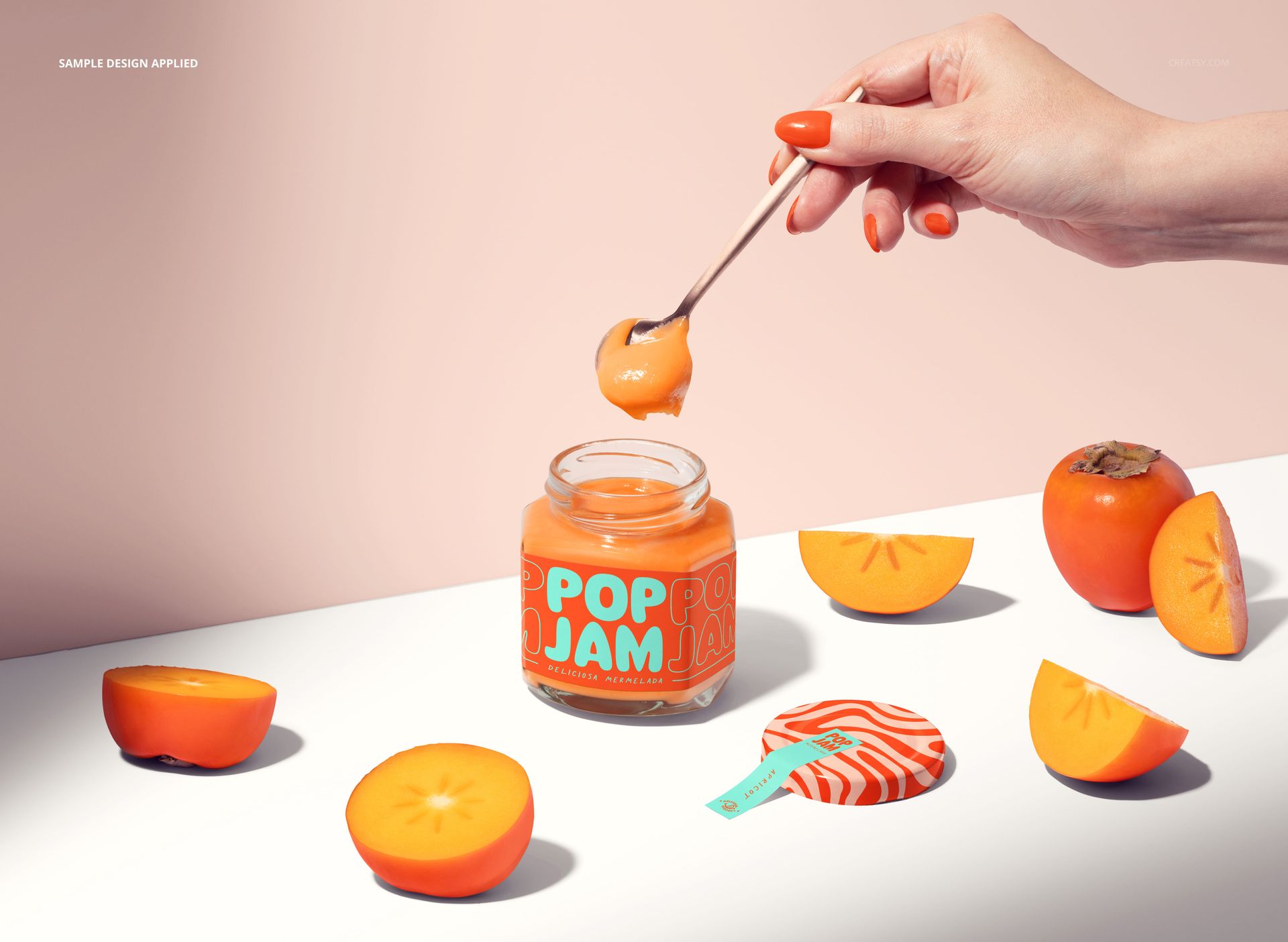 PSD mockup showing a jam jar with orange jam, patterned label, and persimmons, styled on a white tabletop with soft lighting.