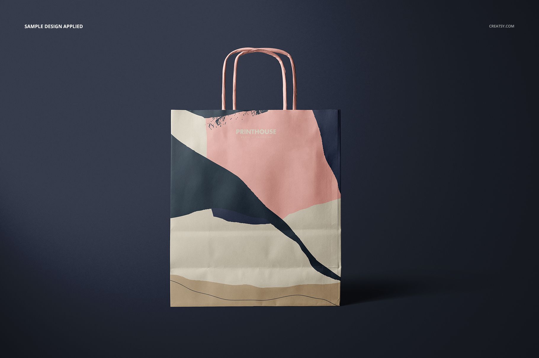 Twisted handles paper bag mockup featuring a modern abstract design in pink, navy, beige, and cream tones.