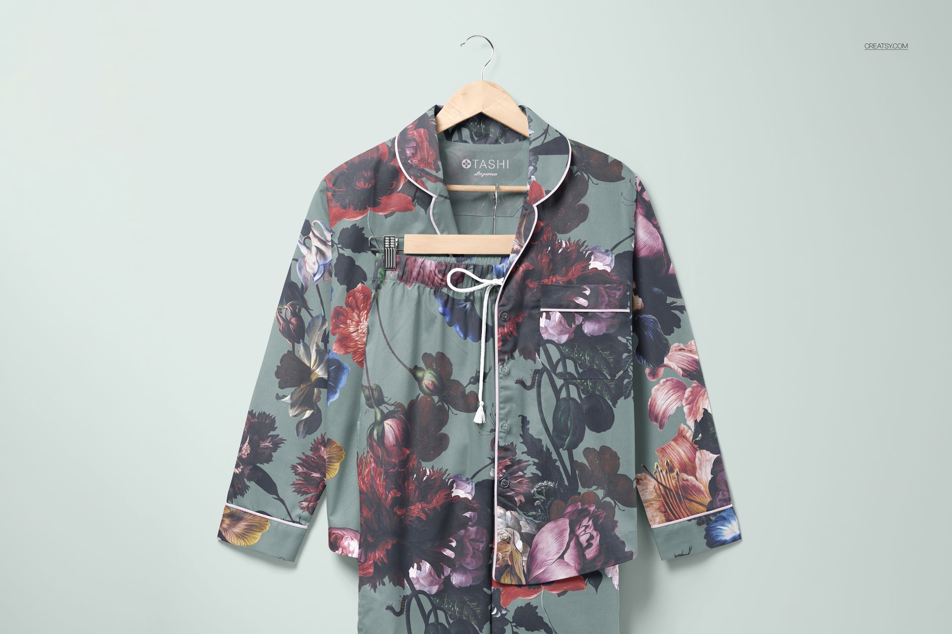 Front view of a long-sleeve pajama set with pants mockup featuring a floral pattern on a gray background.