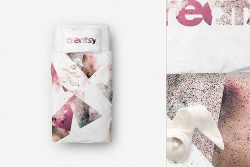 Single bed bedding mockup with abstract pink and brown splatter design, viewed from above, includes plush toy.
