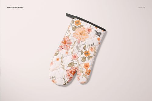 Single oven mitt mockup featuring a botanical design with orange flowers and green leaves, displayed flat overhead.