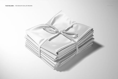 Neatly stacked white satin fabric layers secured with a ribbon, displayed in a realistic PSD mockup setting.