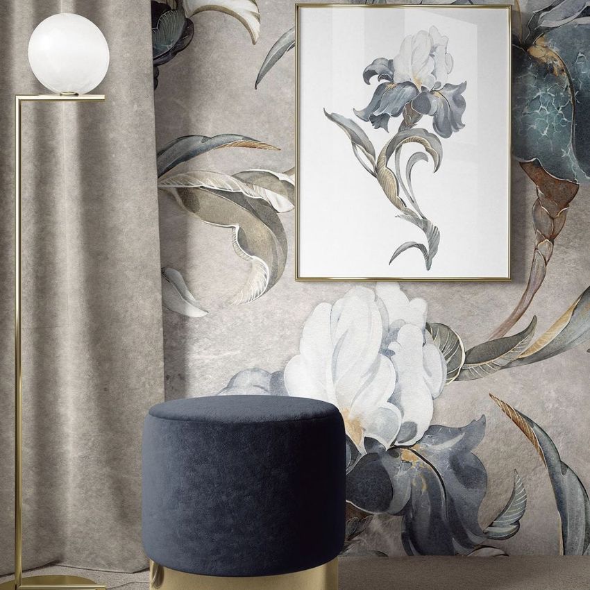 Interior scene mockup featuring a framed floral artwork on a wall with large botanical patterns, a curtain, and a blue velvet stool.