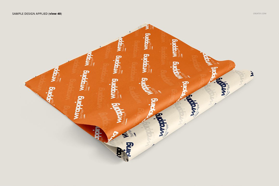 Stacked wrapping tissue paper mockup with orange and white sheets, each featuring a repeating text pattern, top perspective.