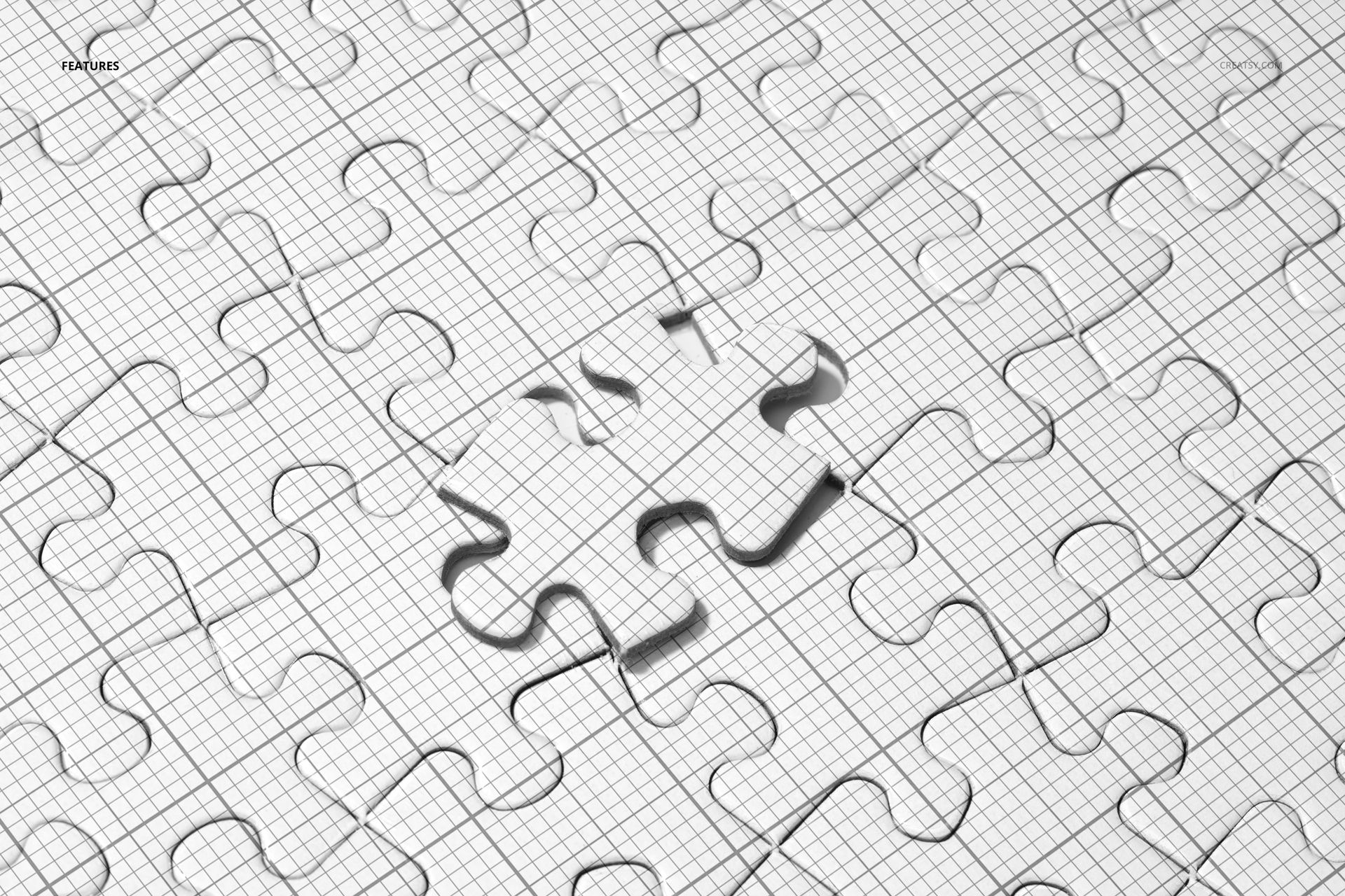 Top view of a heart jigsaw puzzle mockup with grid lines and one piece removed, showing shadow details.