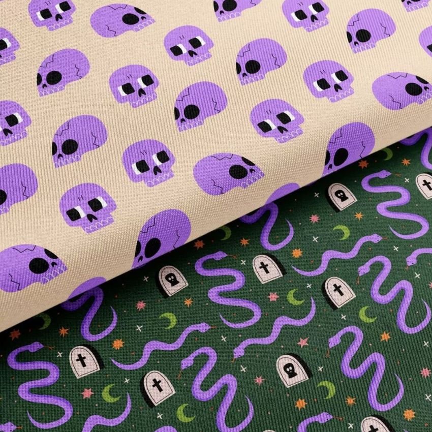 Twill silk fabric mockup featuring a closeup of two patterns: purple skulls on beige and Halloween motifs on dark green.