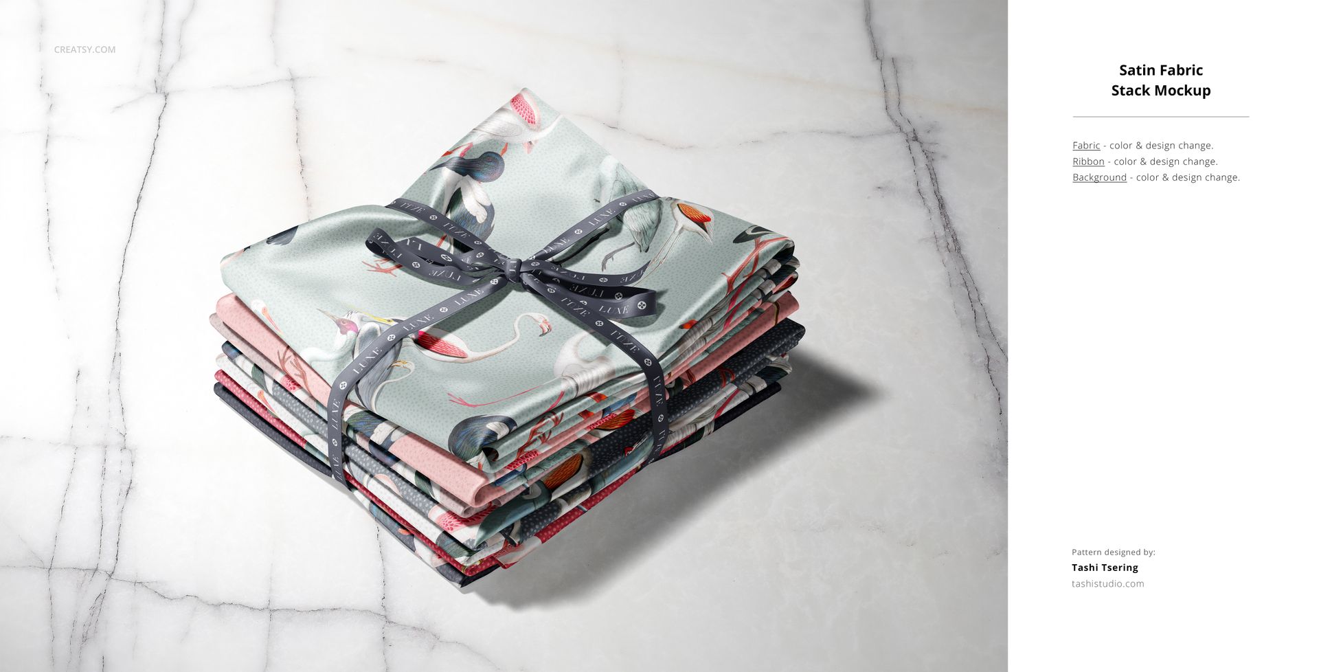 PSD mockup featuring a bundle of folded fabric swatches in assorted designs, arranged neatly with a black ribbon.