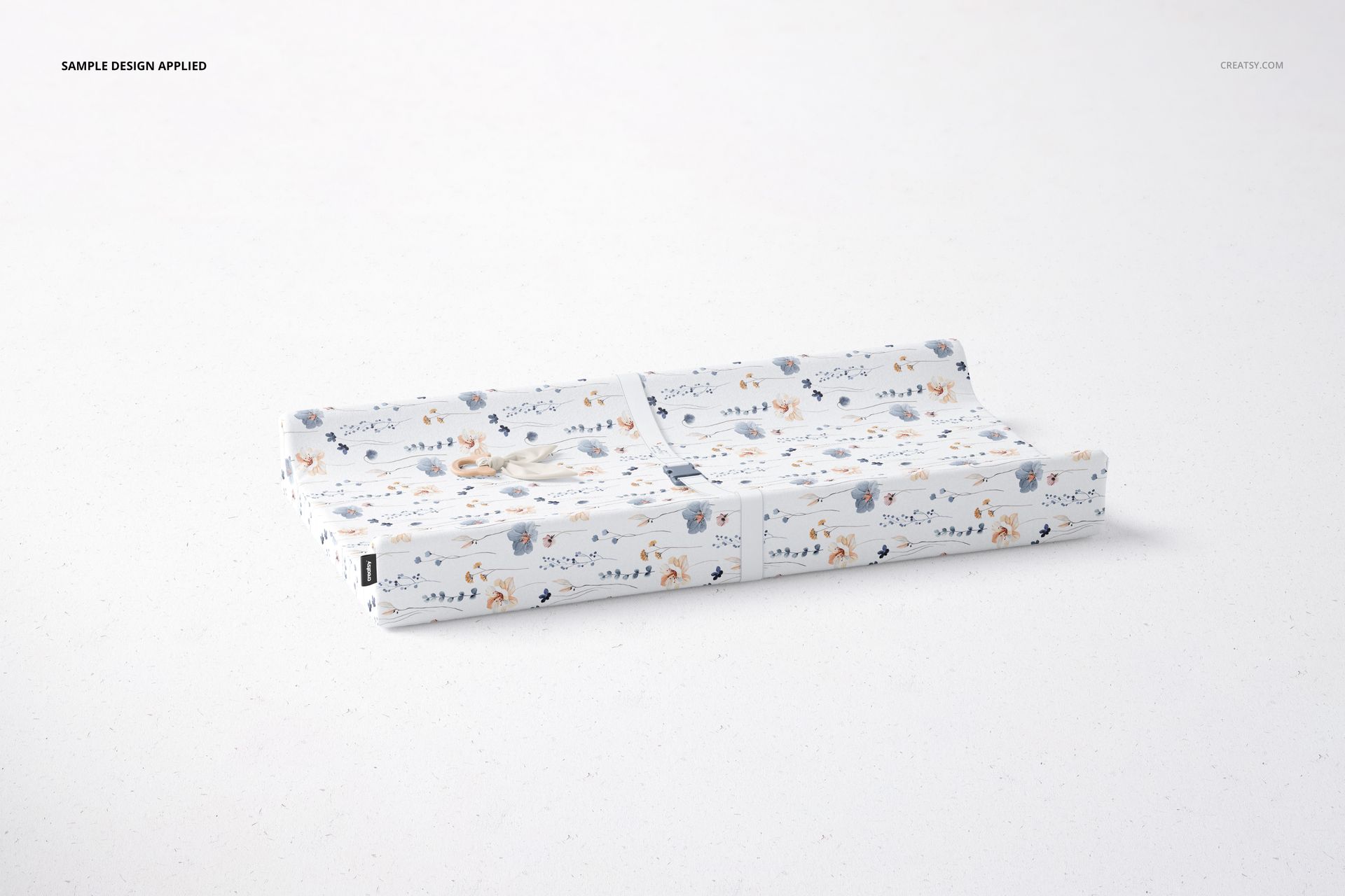 Kids changing pad mockup displayed on a light surface, decorated with whimsical animal and nature motifs.