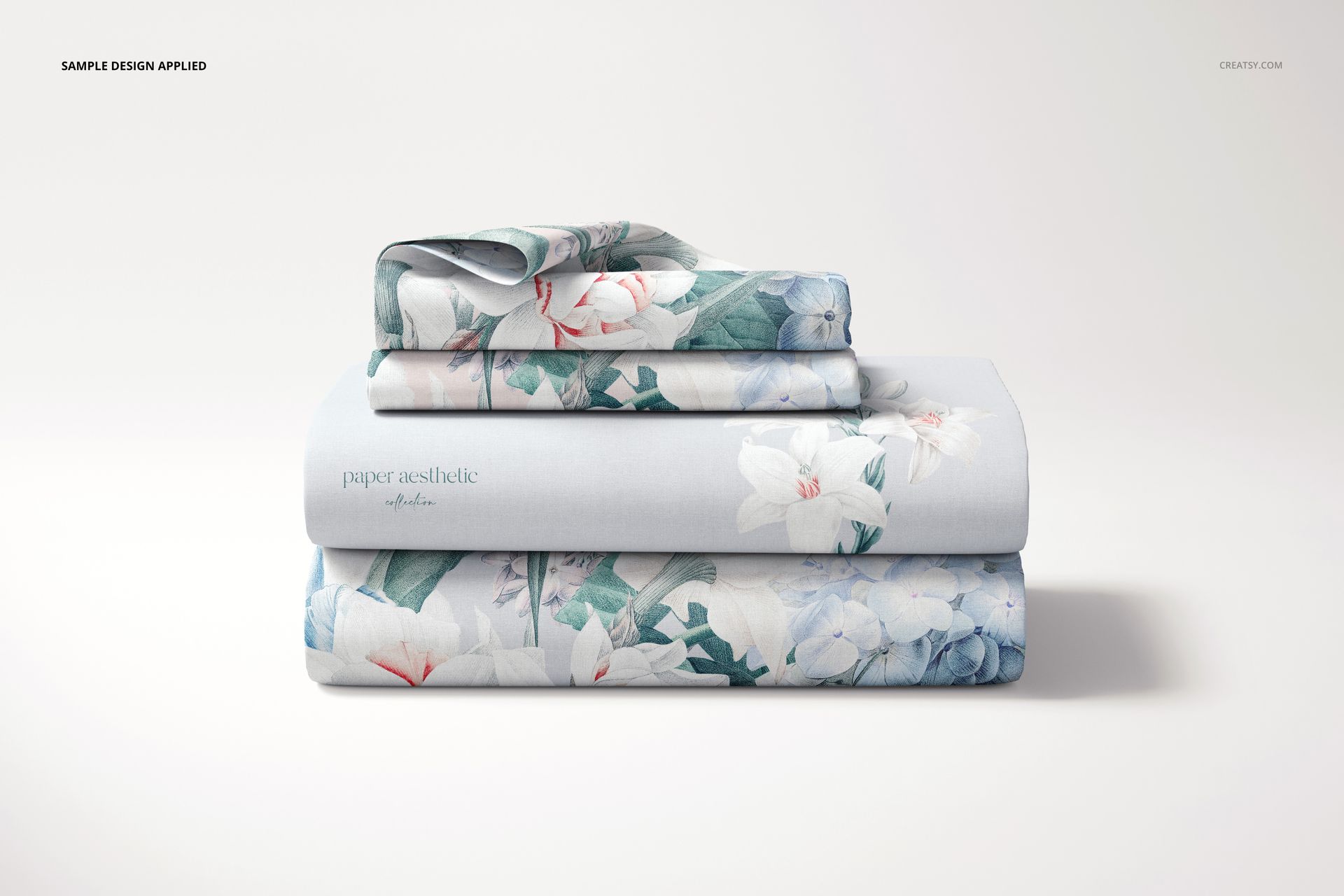 Stacked bedding set mockup featuring folded sheets with botanical print in pastel colors, shown from the front.