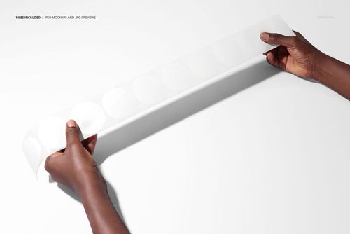 Round sticker tape mockup held between two hands, featuring blank circular stickers on a white studio background.