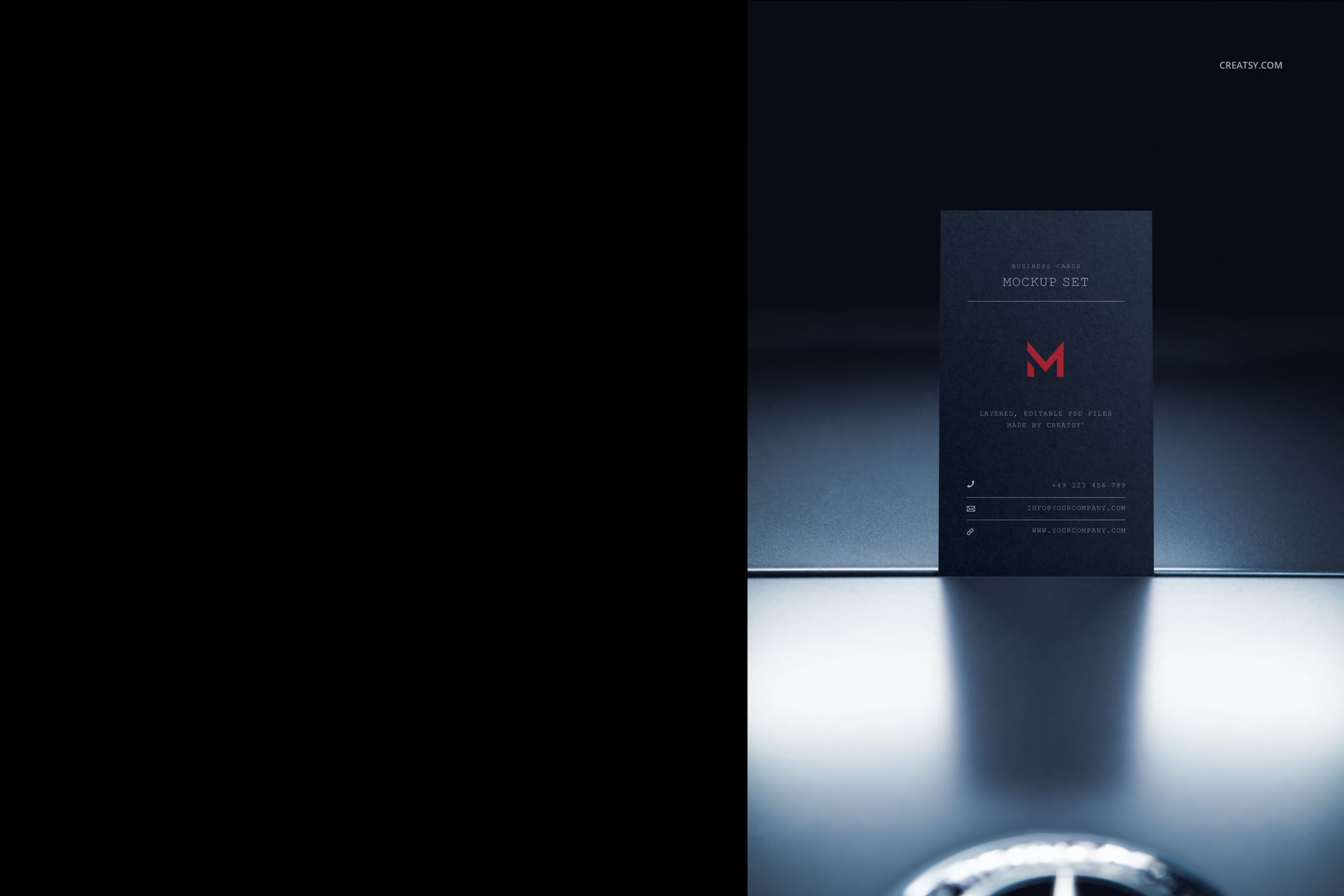 Dark automotive business card mockup standing upright on a reflective surface, front view with minimal lighting.