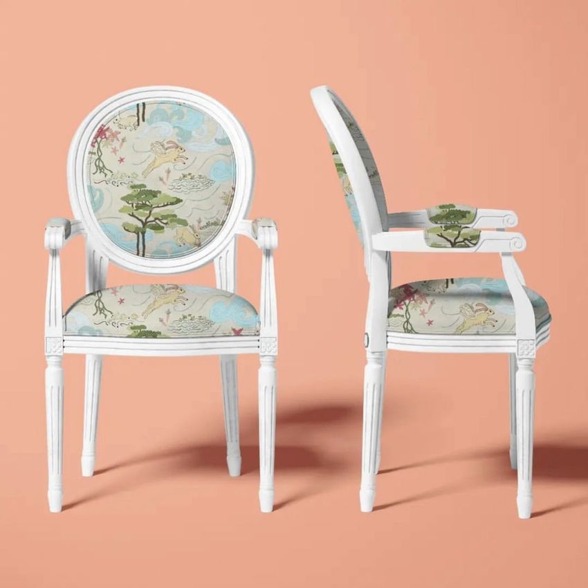 Louis XVI medallion back armchair mockup showing two white chairs with whimsical rabbit and tree pattern upholstery on a peach background.