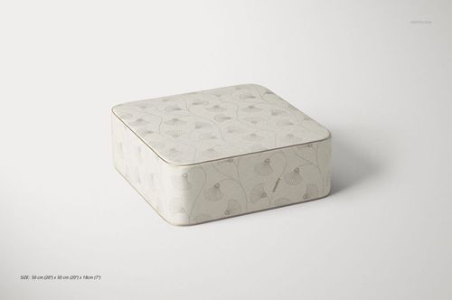 Mockup of a square velvet pouf featuring a soft beige color and delicate leaf design, displayed on a plain surface.