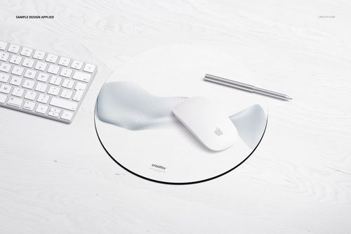 Circular mouse pad mockup featuring a light pattern, displayed with a keyboard, mouse, and pen on a pale desk.
