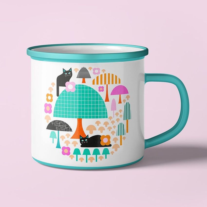 Enamel mug mockup with a turquoise rim and handle, featuring a playful illustration of black cats, mushrooms, and trees on a white surface.