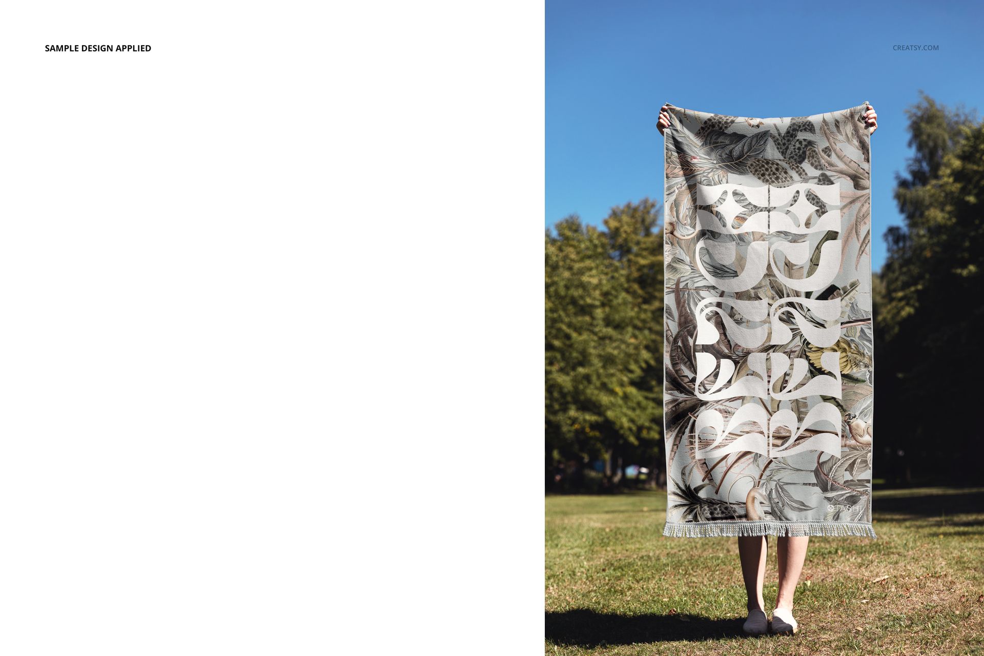 Fringed beach towel mockup displayed vertically, featuring decorative patterns, held by a person in a park setting.