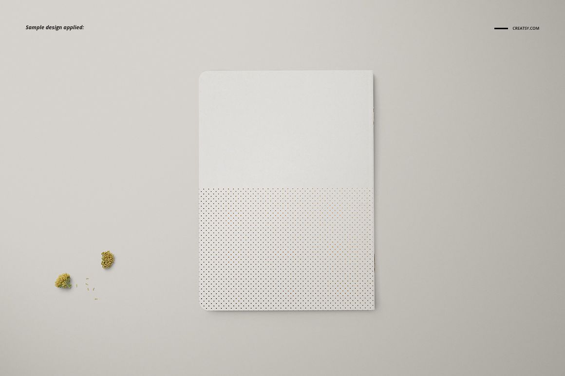 Top view of an A5 classic notebook mockup with a minimalist white cover and subtle dotted pattern at the bottom.